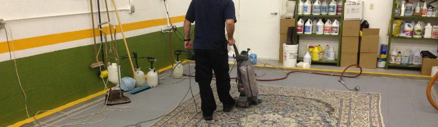 Technician working on a Persian rug on the wash floor of the Fort Lauderdale shop