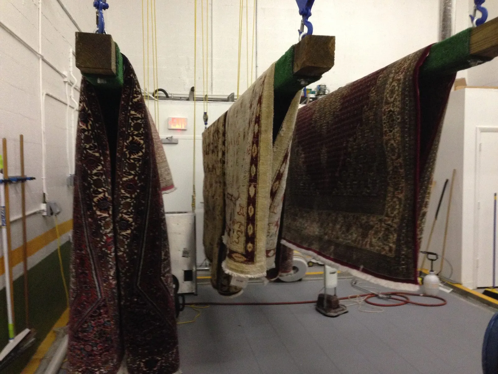 Oriental rugs on the hoist hanging system after washing